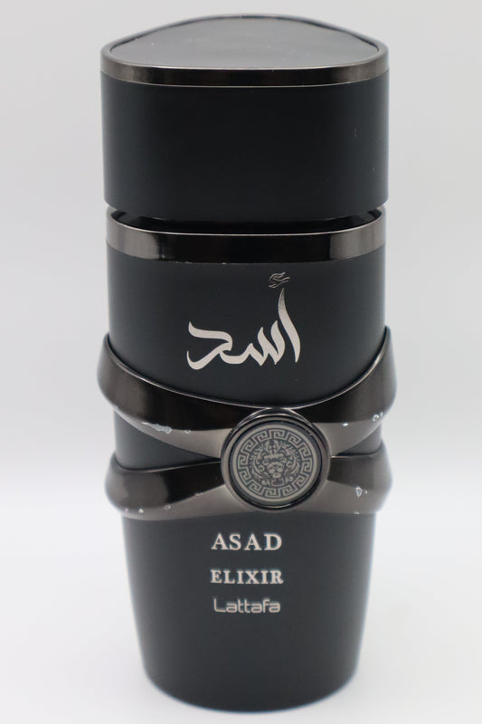 A black cylindrical bottle of Asad Elixir Lattafa perfume with Arabic calligraphy on the front, a silver emblem on the middle band, and white text at the bottom, set against a plain light gray background.
