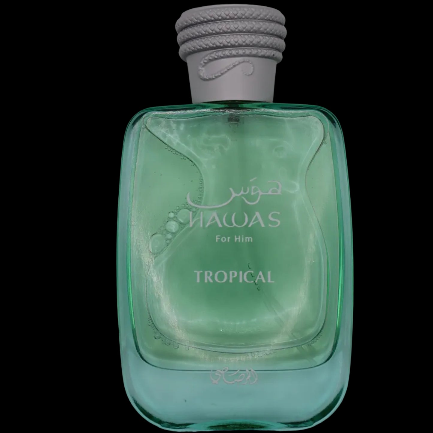 A bottle of HAWAS For Him Tropical cologne, featuring a translucent light green glass bottle and a textured gray cap, set against a plain light gray background.