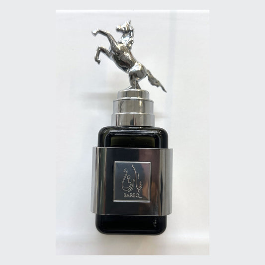 Ard Al Zaafaran Bareq bottle in black glass with a rearing horse cap, photographed at the Sheikh Scents shop