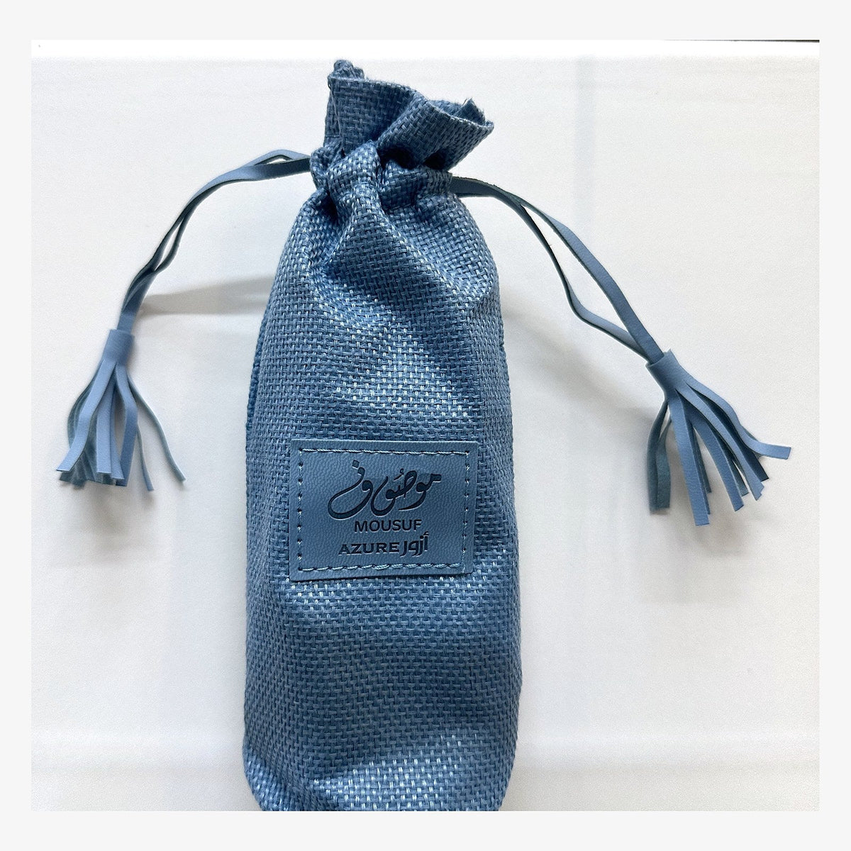 Blue drawstring pouch that Ard Al Zaafaran Mousuf Azure comes in, photographed at the Sheikh Scents shop